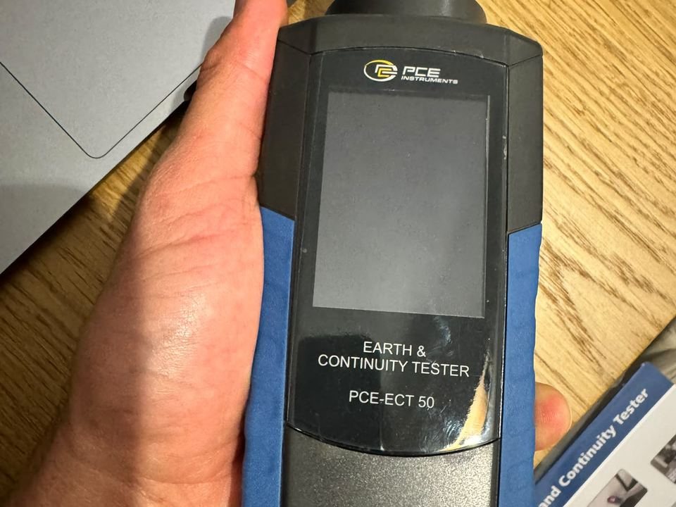 Technician holding a PCE-ECT 50 earth and continuity tester