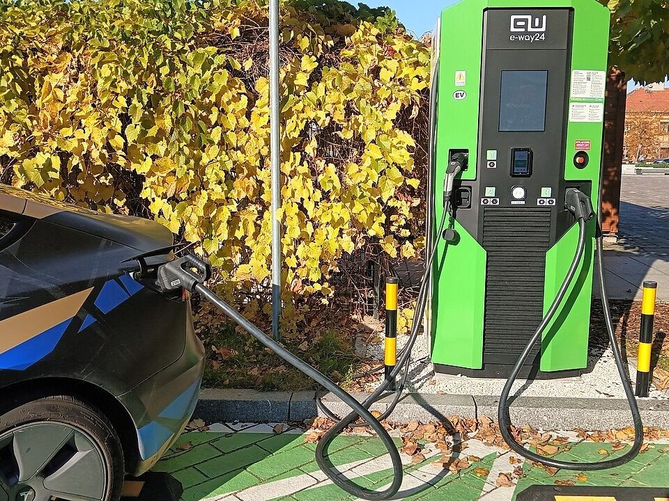 Electric car connected to a DC fast charger outdoors