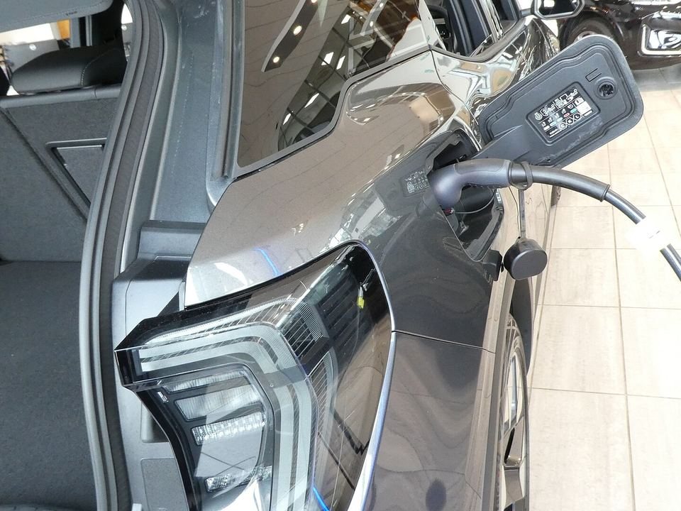 Charging connector plugged into an electric car