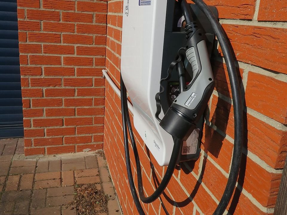 Wall-mounted AC charger on a brick wall