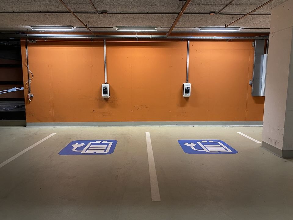 Underground car park with marked EV charging bays