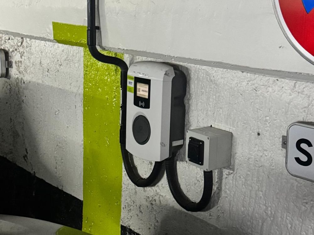 EV charger and its dedicated protection enclosure installed by D-Voltaris in a car park